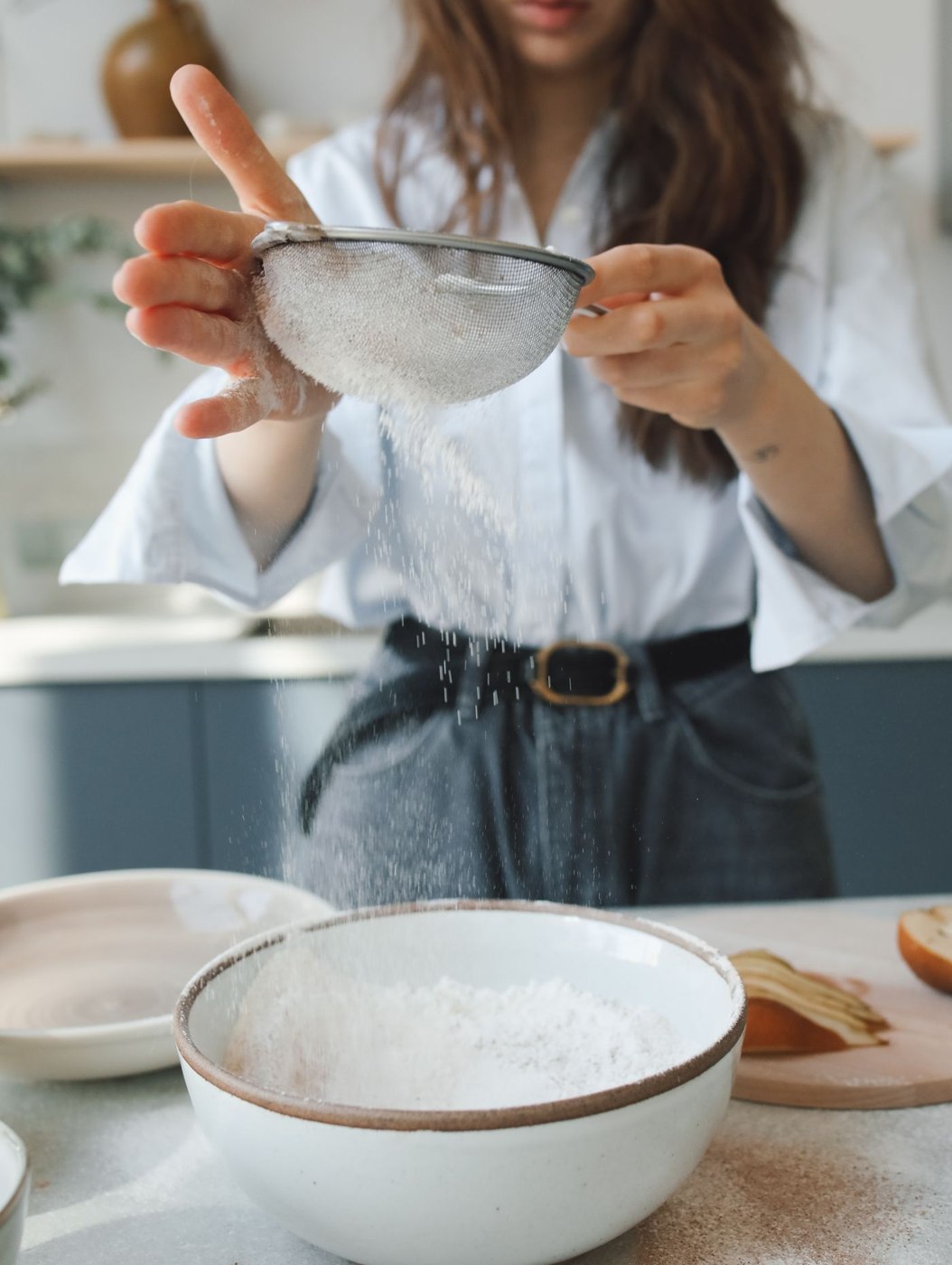Flour preparation illustrates a bowl-based kitchen task; the scene is not a test of the scales reviewed.